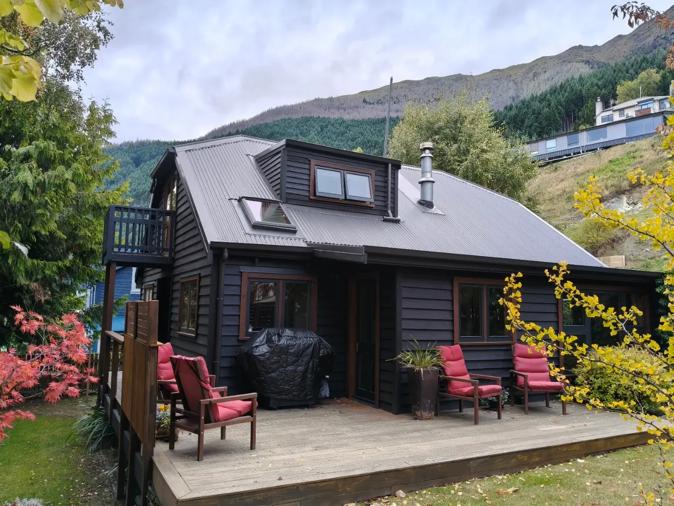 Charcoal weatherboard home with deck after an exterior repaint