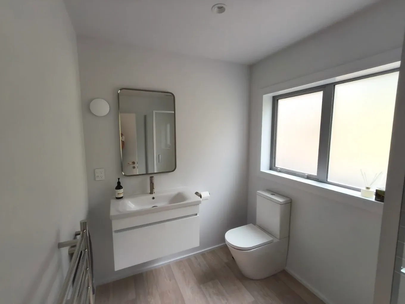 Bathroom vanity and mirror with painted walls