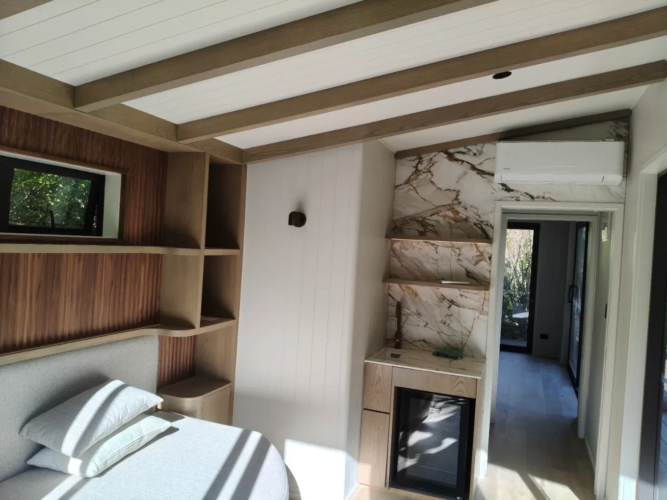 Bedroom with timber joinery, stone and painted linings